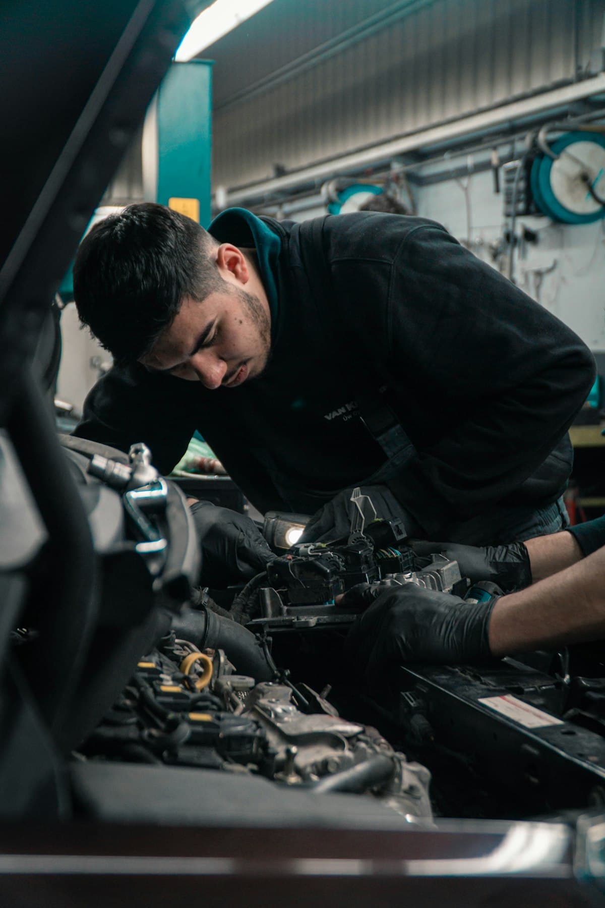 Technician performing routine maintenance on a vehicle